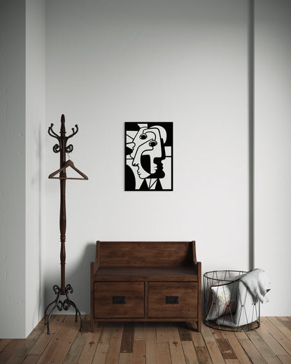 Cubist faces wooden wall decoration hangingg on a white wall